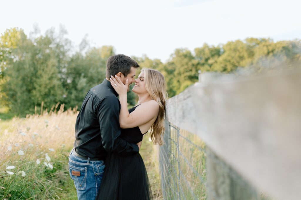 A couple poses for their country themed engagement photos at Danada Equestrian center in Wheaton Illinois.