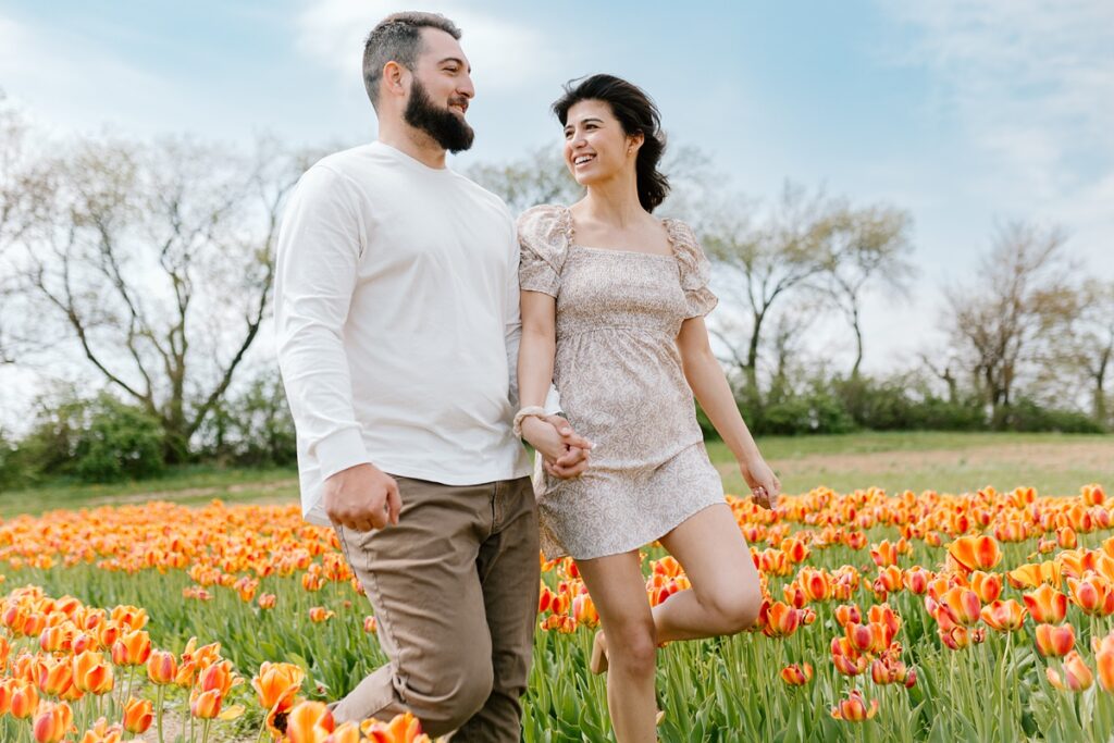 Tulip field maternity photos of a young couple at the Kuipers Midwest Tulip Fest