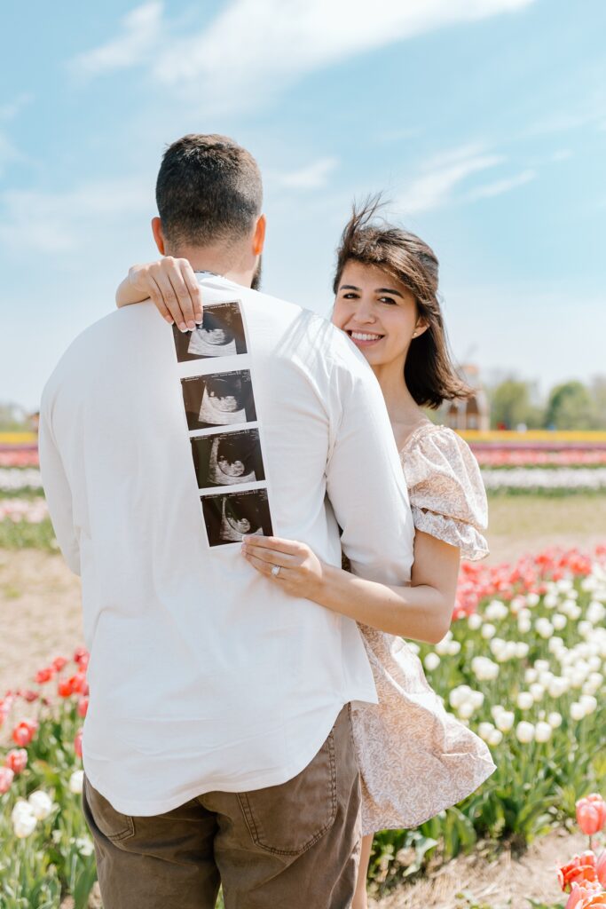 Tulip field maternity photos of a young couple at the Kuipers Midwest Tulip Fest