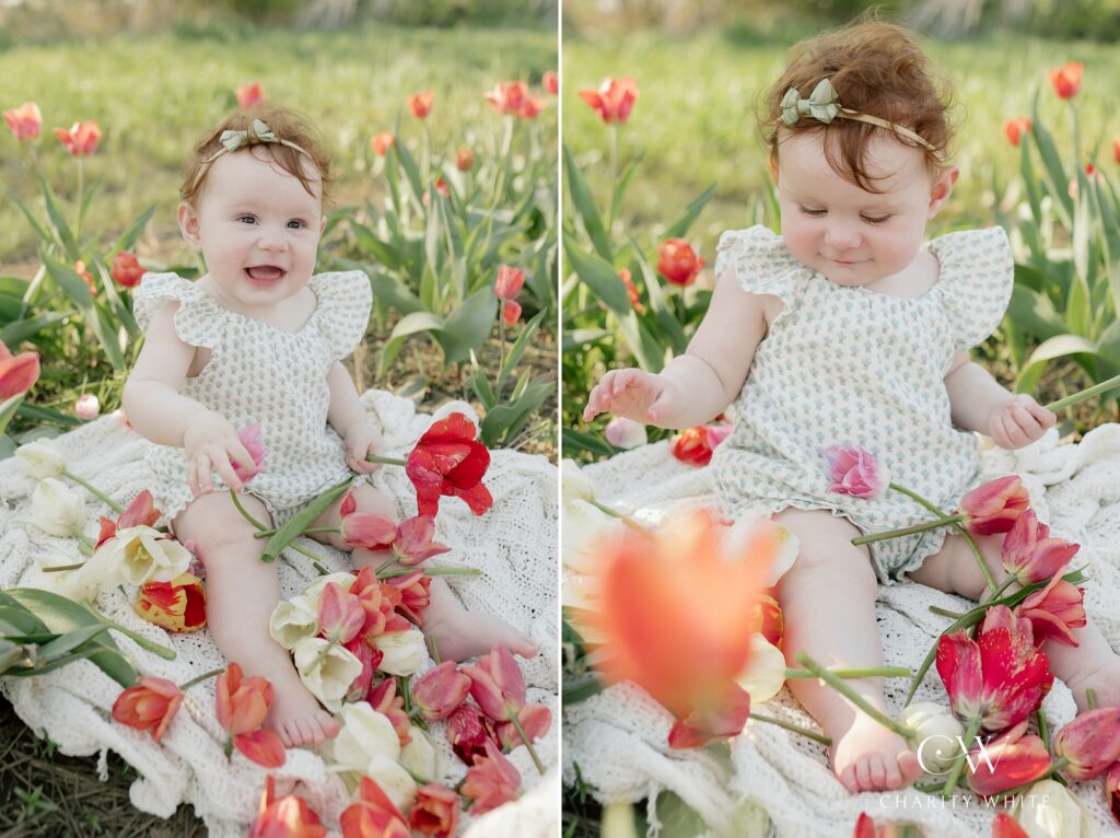 Baby sitting by herself directly in a field of colorful tulip petals.